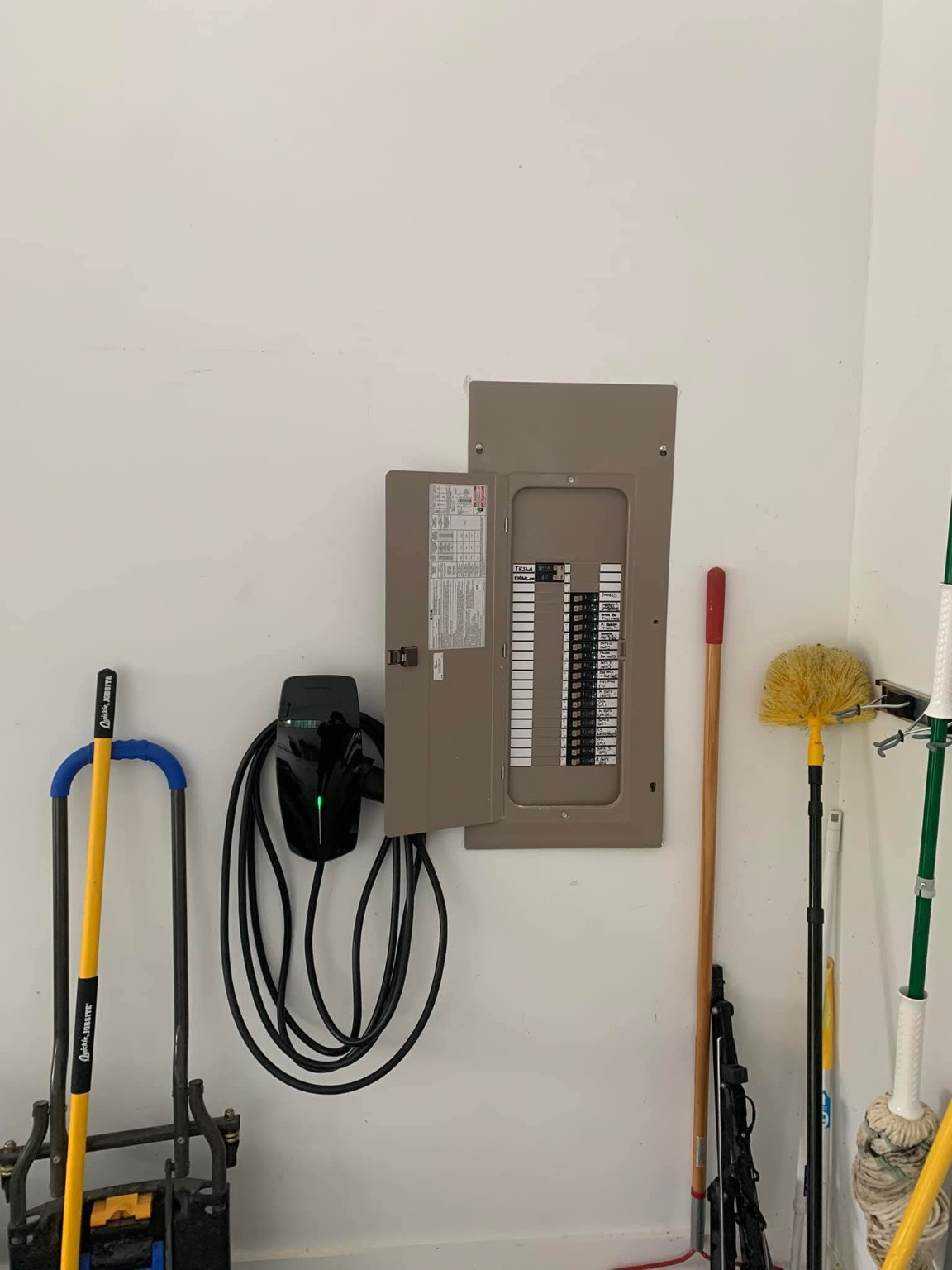 EV charger installed next to electrical panel